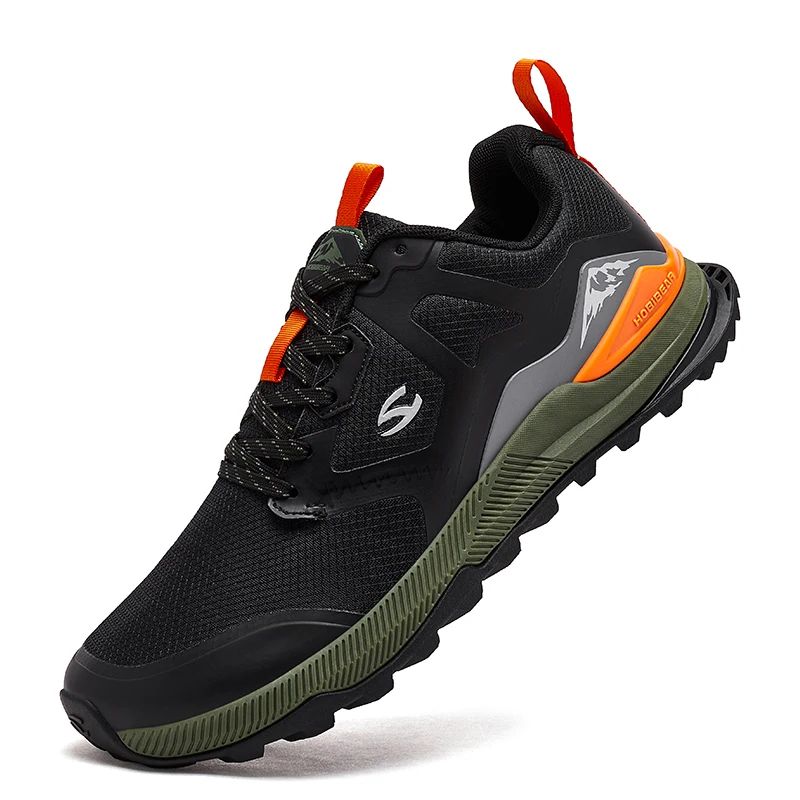 Black and green athletic shoe with orange accents on a white background