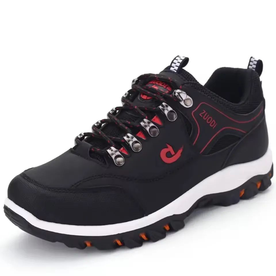 Black hiking shoe with red accents and white sole on a white background
