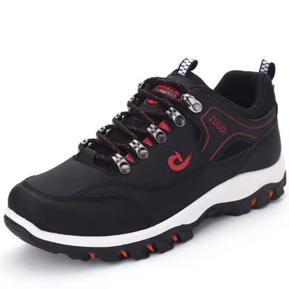 Black hiking shoe with red accents and white sole on a white background