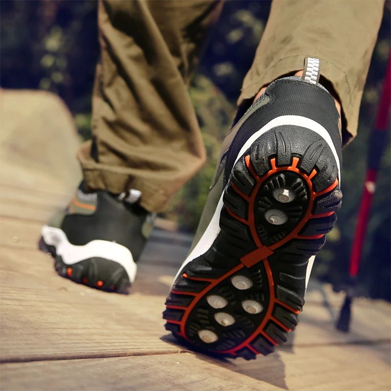 Close-up of hiking shoes with unique sole design on a wooden surface.