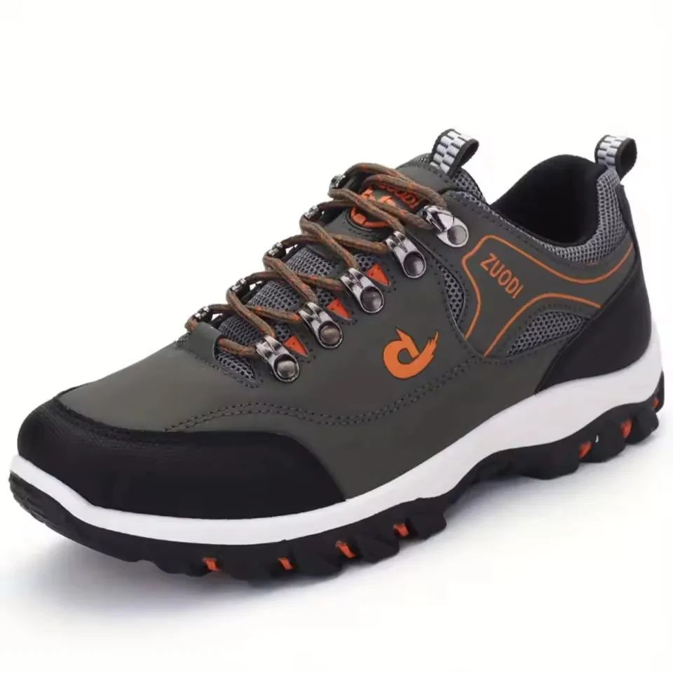 Gray hiking shoe with orange accents on a white background