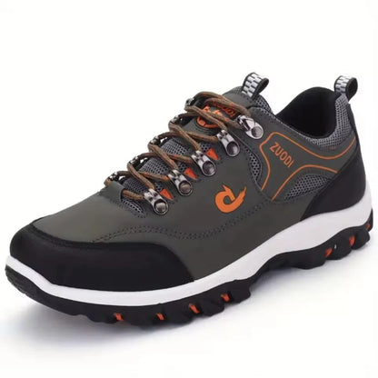 Gray hiking shoe with orange accents on a white background