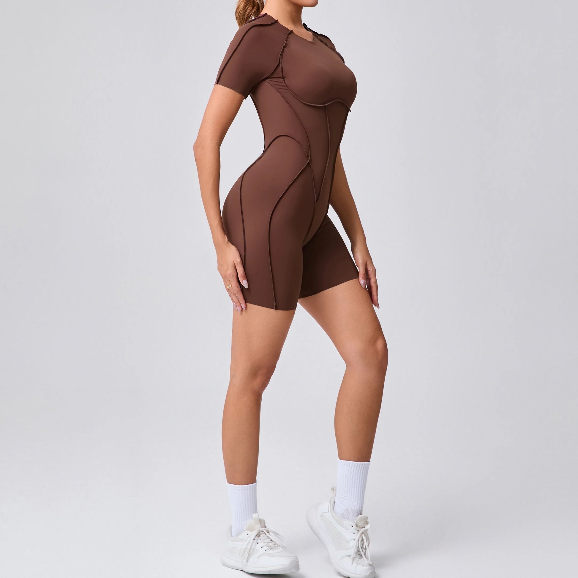 Brown bodysuit worn by a person on a white background