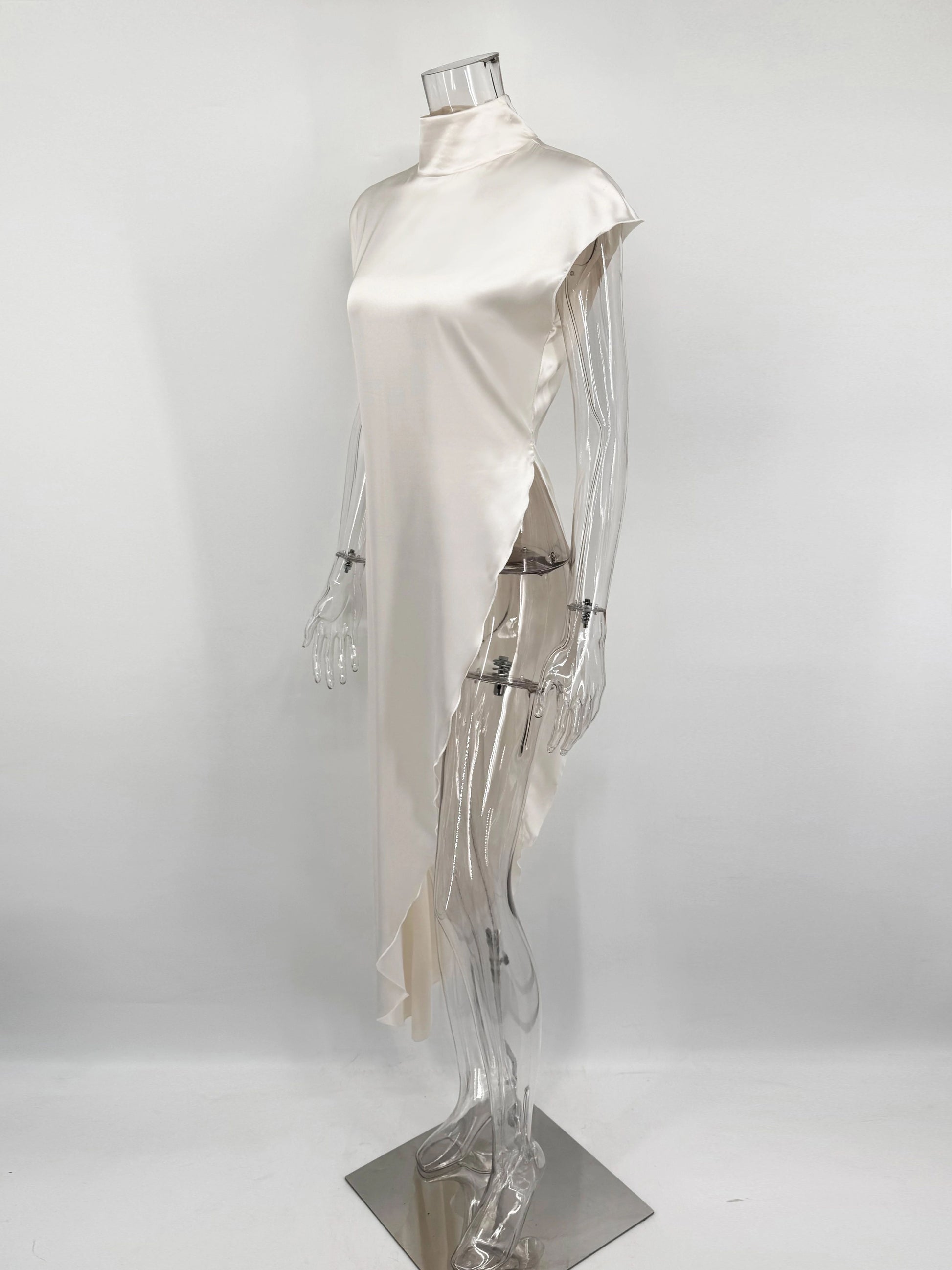 Mannequin wearing a white dress on a plain background