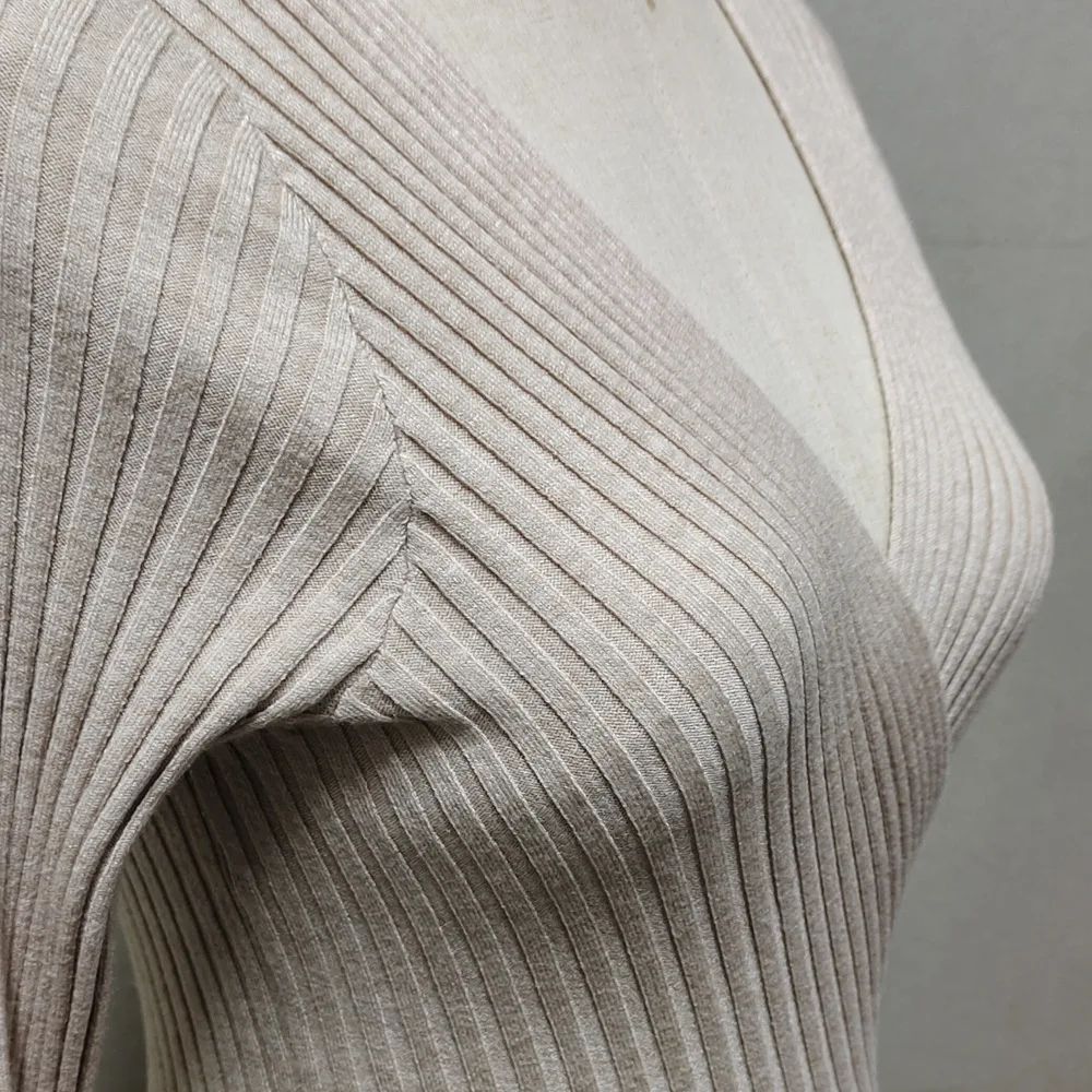 Close-up of ribbed fabric texture on a neutral background