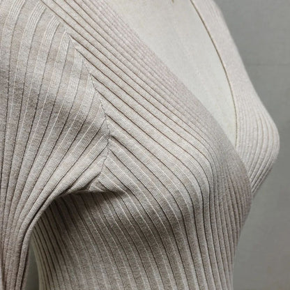 Close-up of ribbed fabric texture on a neutral background