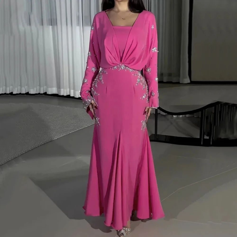 Pink evening gown with silver embellishments on a neutral background