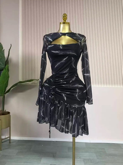 Black patterned dress on a mannequin against a neutral background
