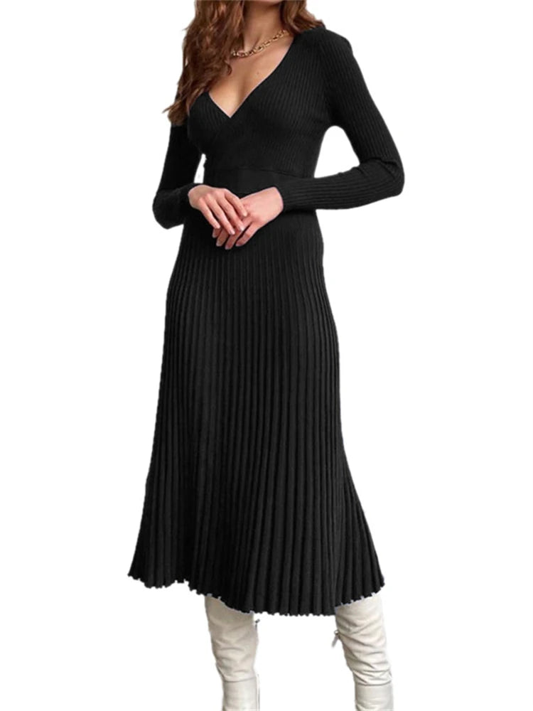 Black pleated dress worn by a person on a white background