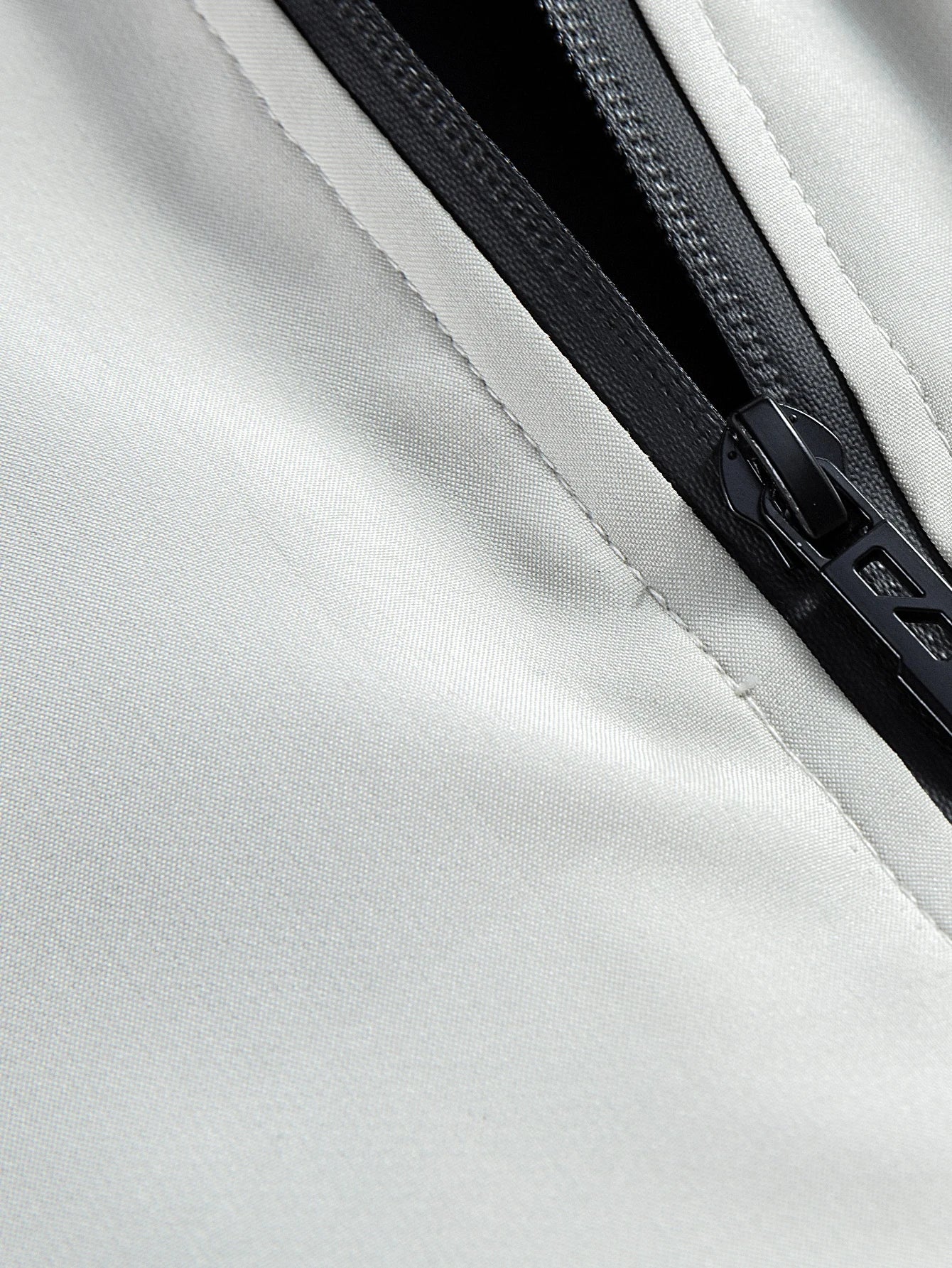 Close-up of a zipper on a white jacket