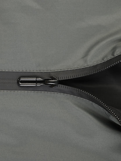 Close-up of a zipper on a gray fabric surface