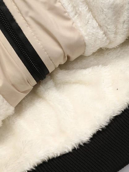 Close-up of a beige jacket with black zipper and white fur lining