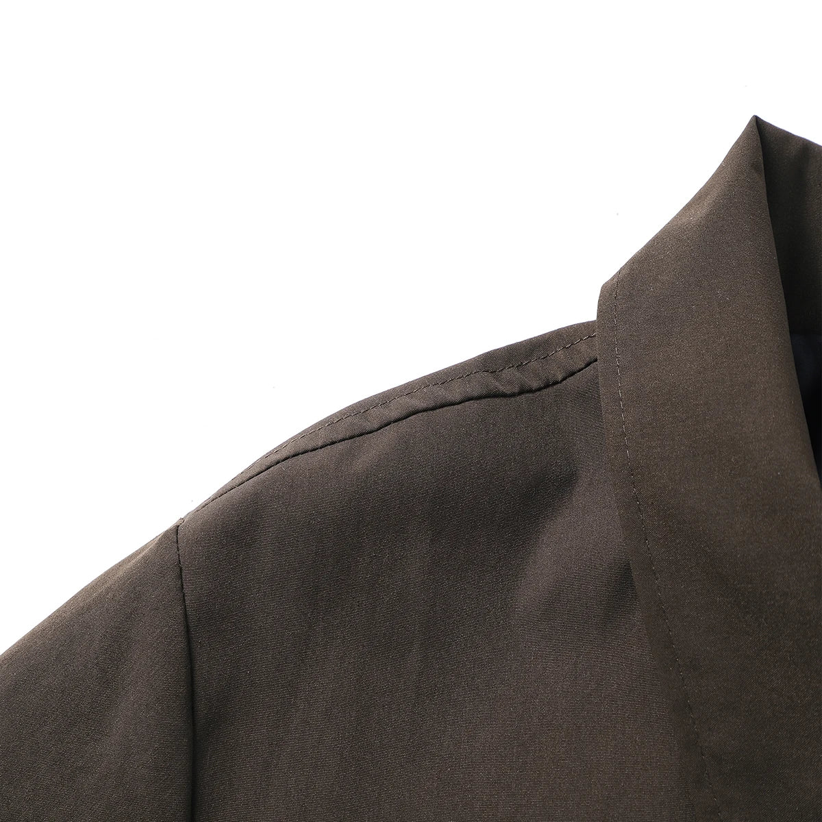 Close-up of a dark brown garment with a collar on a white background