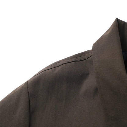 Close-up of a dark brown garment with a collar on a white background