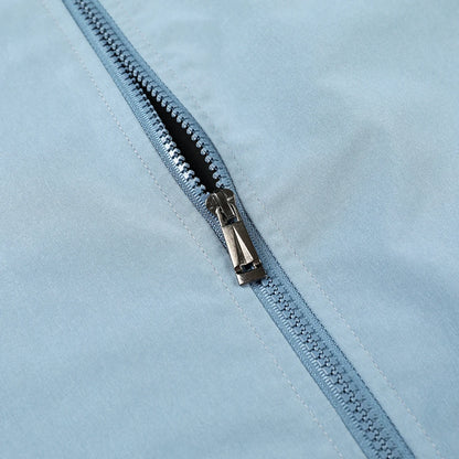 Close-up of a zipper on a light blue fabric background