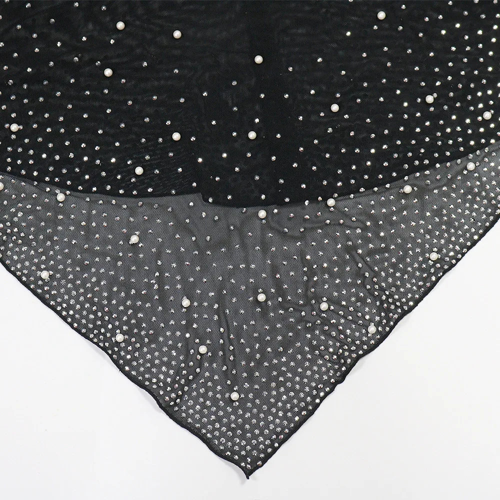 Black fabric with white polka dots on a white background