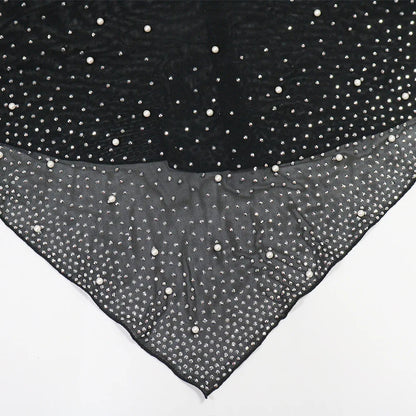 Black fabric with white polka dots on a white background