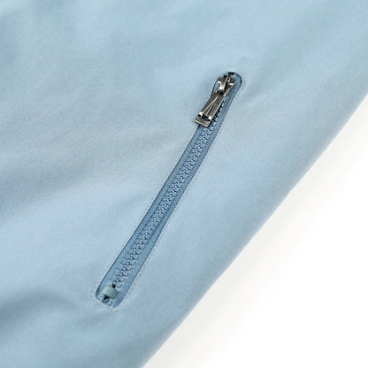 Light blue shirt with a zipper detail on a light gray background
