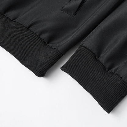 Close-up of a black jacket with ribbed cuffs on a white background