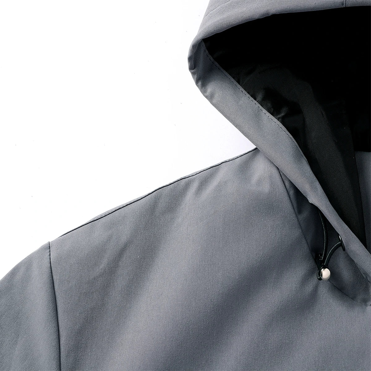 Close-up of a gray hooded jacket on a white background