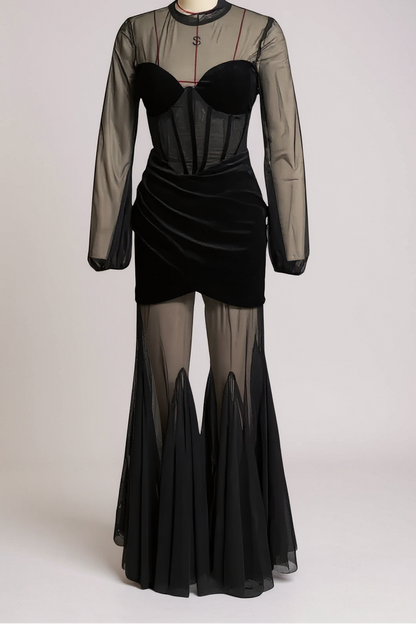 Black dress with sheer overlay on a mannequin against a white background