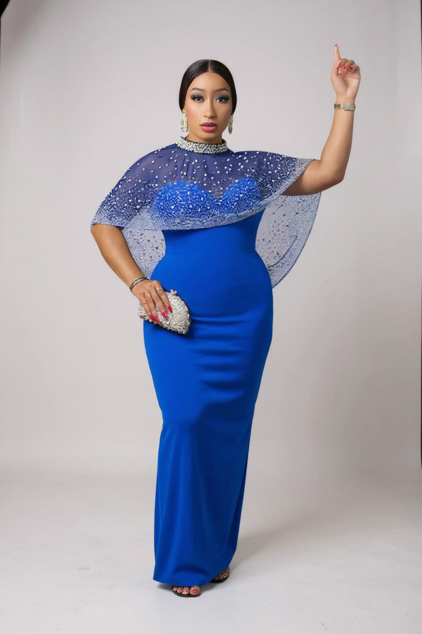 Woman wearing a blue dress with a cape on a white background