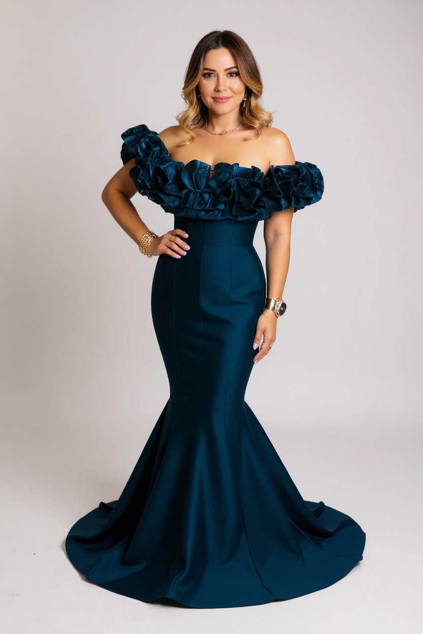Woman wearing a dark blue off-shoulder gown with floral details on a white background